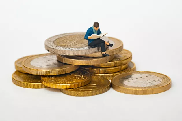  a man sitting on a pile of money.picture